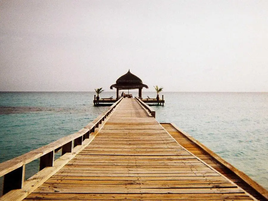 Wooden pier leading into a turquoise sea